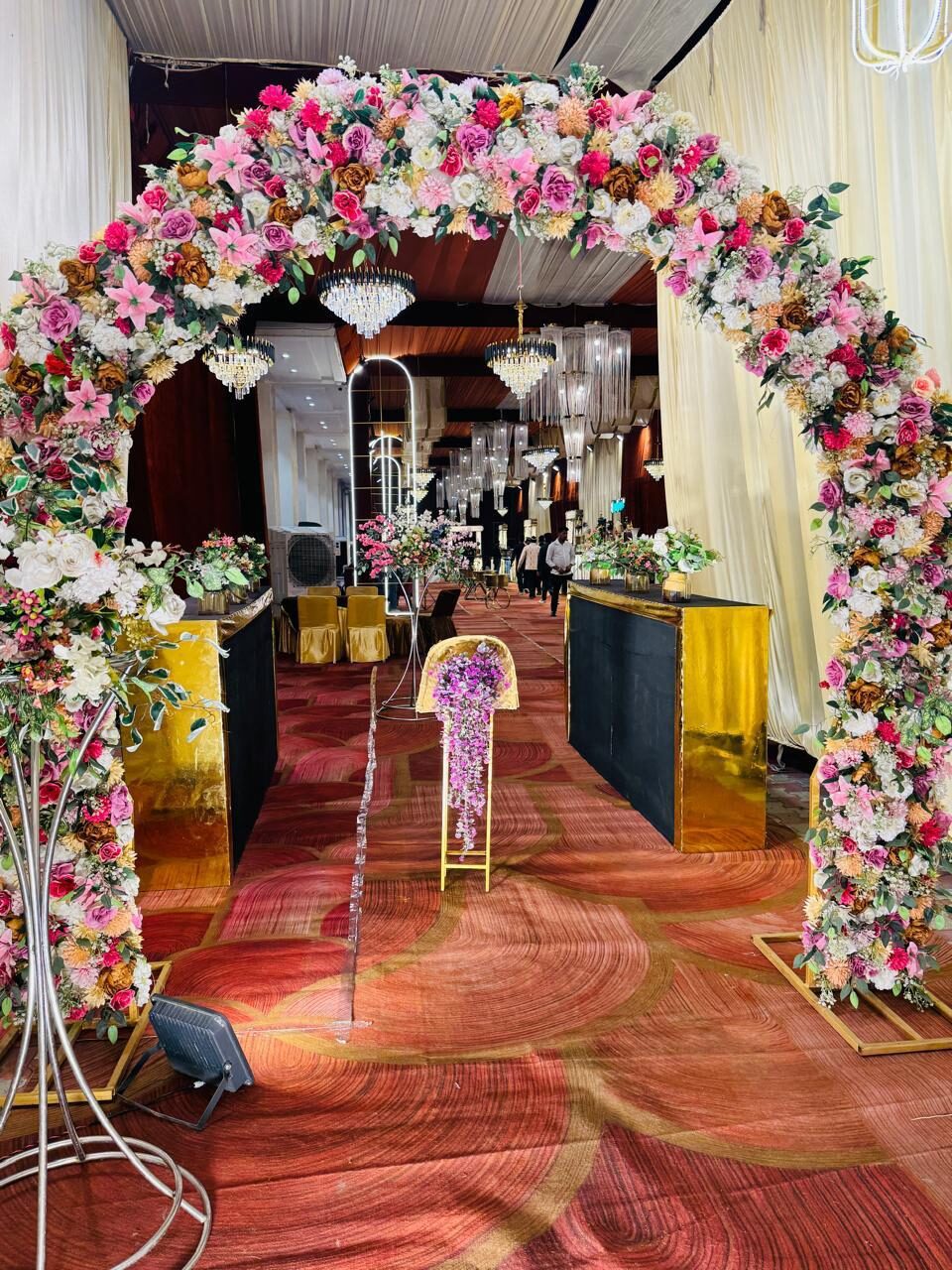 Pink floral arch aisle